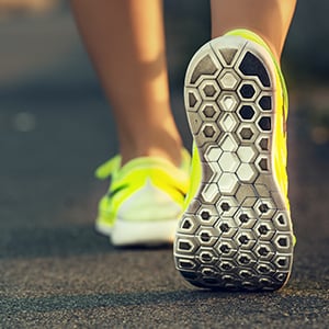 A person wearing running shoes. Athlete’s foot is a fungal infection that usually thrives in warm, damp places.