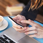 A woman holding her Smartphone. In 2008, the Scientific American publication explained the danger of Wi-FI on the human brain.