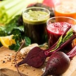 A glass of beet juice and a leafy green juice. Juice fasts are one of many natural cleansing methods for detoxing your body.