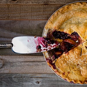 3 layer goji and blueberry peach pie on a wooden counter. This goji pie helps protect against free-radical damage.