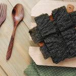 A layer of seaweeds on a wooden platter. Try to drink fluoride-free water and go gluten free to Support thyroid health.