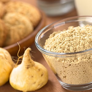 A powder form of a maca root in a glass container. Maca is considered a superfood that is beneficial for women.