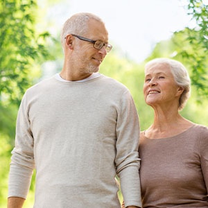 An older couple walking in nature.