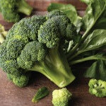 Broccoli on a wooden table. The alkaline diet is a term describing diets that are aimed at balancing the ph levels of the body.