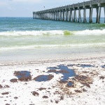 A beach polluted with oil from an oil spill. Oil dispersants are toxic to humans and the environment.