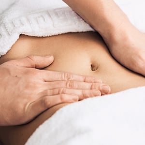 A woman getting an abdominal massage.