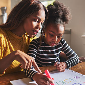 A woman drawing with her daughter.