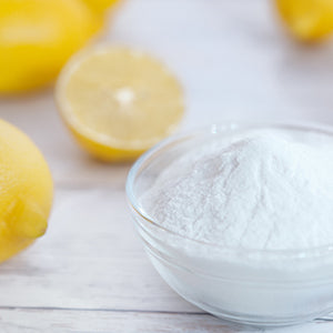 A bowl of baking soda and lemons.