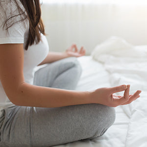 A woman meditating.