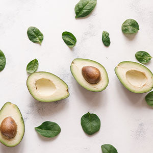 Several avocados on a cutting board.