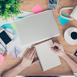 A woman who is unable to concentrate and experiencing brain fog while working on multiple tasks.