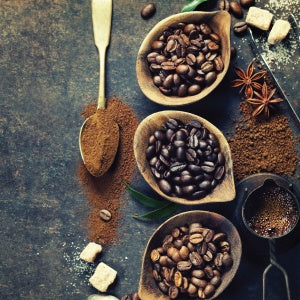 A bowl full of coffee beans. Coffee grounds can be used as a mulching agent.