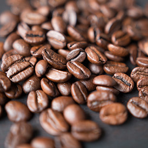 Table full of coffee beans. One of the harmful effects of caffeine is dehydration.