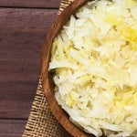 A wooden bowl of sauerkraut. Fermented foods like sauerkraut aren’t the most popular food but it's great for the gut.