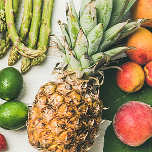 A board of fresh vegetables and fruits.