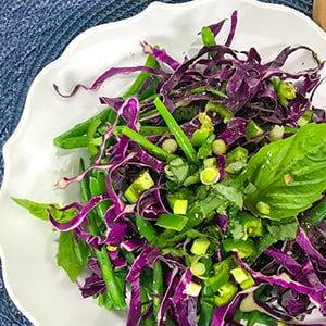 A bowl of green bean salad. This tasty recipe is packed with nutrients and only has 151 calories per serving.