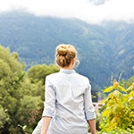 A woman in the middle of a field. Consuming probiotics can help you maintain a healthy gut.