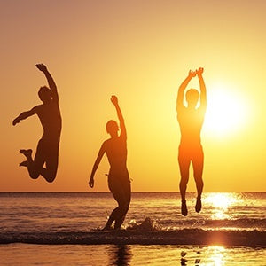 People enjoying the beach. Brain protection and longevity are one of many health benefits of fasting.