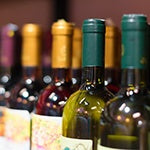 A bunch of wine bottles on a shelf. The best way to protect the gut microbiome from alcohol is to stop consuming alcohol.