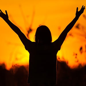 A person is raising their hand. Lactobacillus rhamnosus strain may help with anxiety.