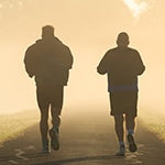 Two middle age men running. As men age, they are prone to suffer from andropause.