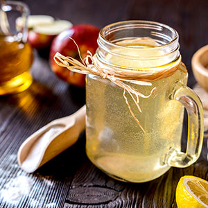 A cup of lemon water with apple cider vinegar.