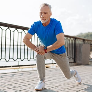 An older man stretching.