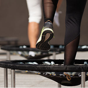 A woman practicing rebounding for weight loss.