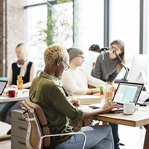 A woman sitting at her desk at work.