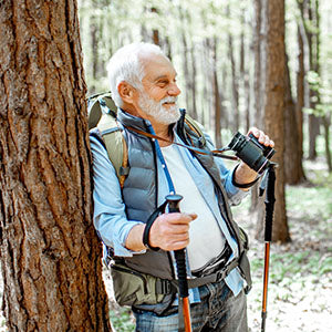 An older man hiking in the wilderness.