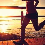 A woman is running on a pier. There are several sources of Vitamins B-12 such as foods, supplements, and b-12 shots.