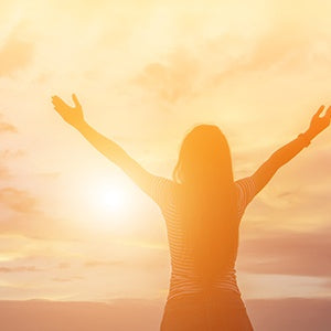 A woman facing towards the sun. Vitamin D3 supplement is the most bioavailable form of vitamin D.