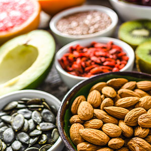 A spread of nuts, seeds, peppers, and fresh vegetables.