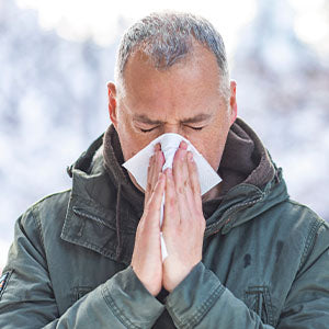 A man blowing his nose.